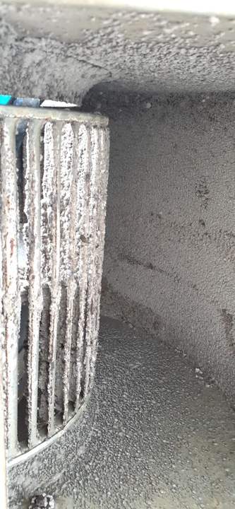 Blower wheel caked with debris inside the housing