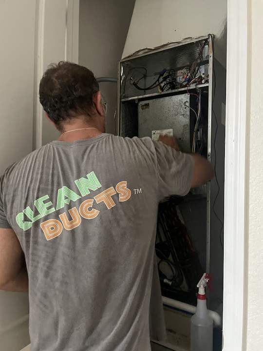 Clean Ducts technician servicing an air handler