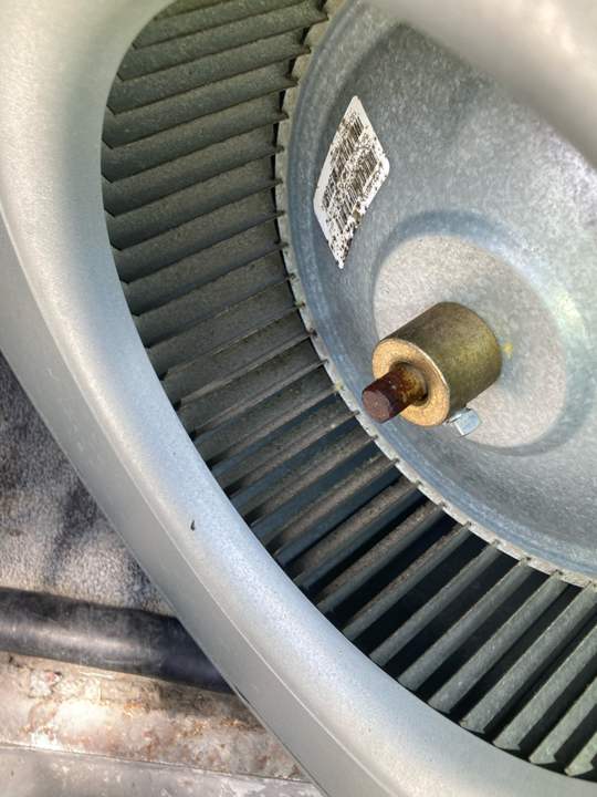 Dust-caked AC blower wheel before cleaning