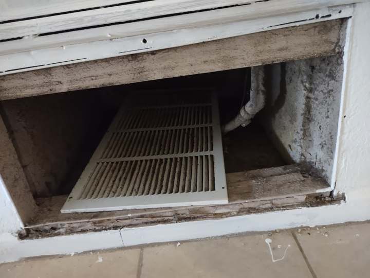 Return air cavity with dust and mold buildup behind the grille